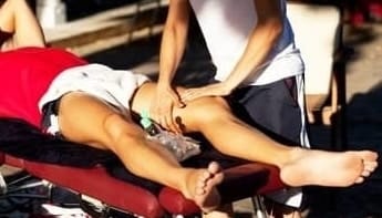 Sports chiropractor treating athlete's knee 
